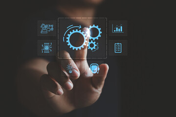 Fototapeta premium Business robotic process automation and workflow optimization concept. Businessman using virtual interface, digital gears icon, system integration, efficiency, technology, smart operation management.