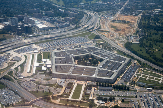 Aerial view of the Pentagon complex with surrounding roads, parking and greenery. g.
