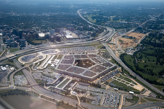 Aerial view of the Pentagon complex with surrounding roads, parking and greenery. g.
