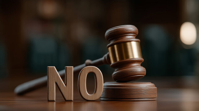 Legal Denial: A close-up shot of a wooden gavel beside the word NO, set in a courtroom. A powerful visual statement.
