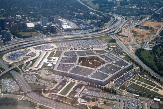 Aerial view of the Pentagon complex with surrounding roads, parking and greenery. g.