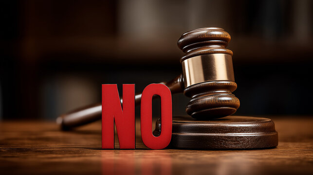 Gavel and The Word NO: A gavel rests on a wooden block, next to the bold word NO, symbolizing authority, denial, and a definitive decision in a legal or decision-making context.