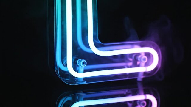 A glowing neon letter L with colorful light and wisps of smoke against a dark background, reflecting on a glossy surface