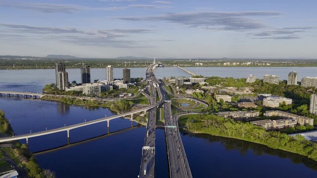 Ile-des-Soeurs Island residential buildings, bridge, and traffic at the sunset, Montreal, Quebec, Canada...