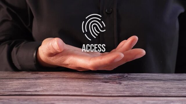 Close-up of a woman's hand on a table holding an animated fingerprint with the word "Access". Biometric access.