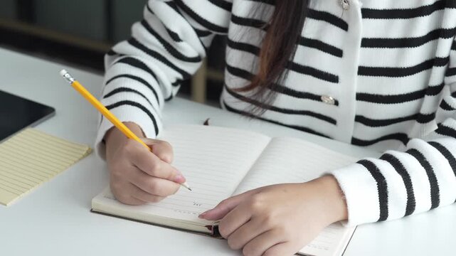 Asian Woman Studying Online on Laptop