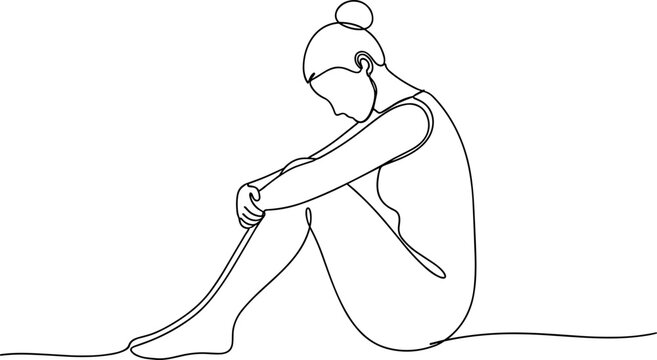 Sad young woman sitting alone.