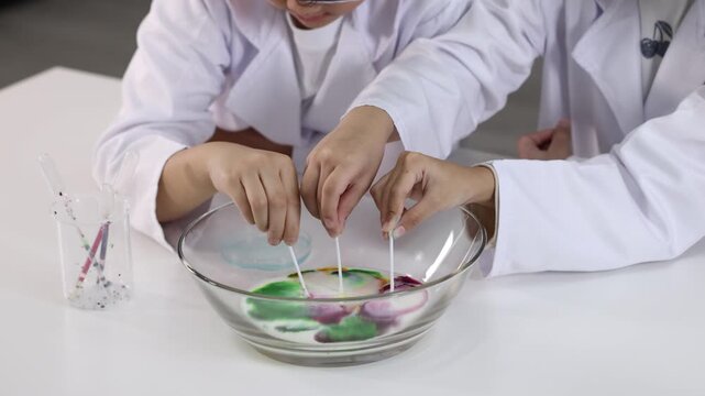 Children in Lab Coats Conduct a Colorful Milk Chemistry Science Experiment