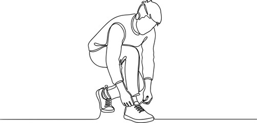 Fototapeta premium Man tying his running shoe laces.