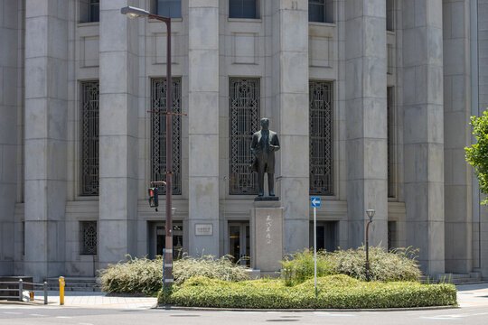 Osaka, Japan - June 29, 2025: A bronze statue of Godai Tomoatsu stands in front of the Osaka Exchange building (formerly the Osaka Securities Exchange) in Kitahama, Chuo Ward.