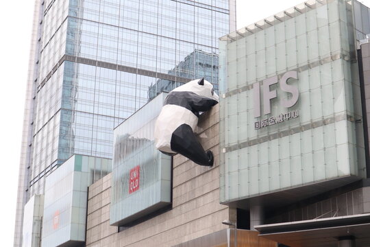 The famous giant panda sculpture climbing the exterior wall of the IFS shopping mall in Chengdu, China, set against modern glass skyscrapers on March 30 2026 in Chengdu, China.