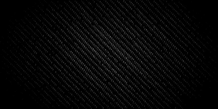 Abstract dark background featuring a woven carbon fiber texture pattern