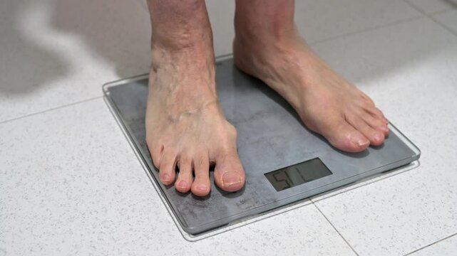 Man Standing On Digital Bathroom Scale S For Health And Fitness Monitoring