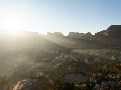 A serene morning view of Trimbakeshwar in Maharashtra, India, featuring soft light over the surrounding hills and sacred landscape.
