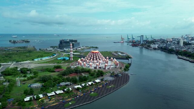 Aerial Coastal View of 99 Domes Mosque in Makassar by Losari Waterfront with CPI makassar as background, masjid kubah 99 makassar.