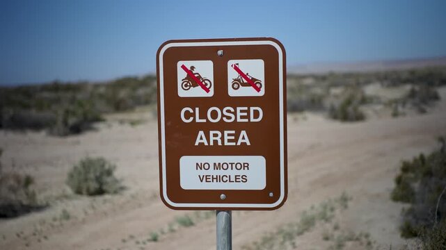 Sign indicates a closed area for no motor vehicles at Salton Sea Recreation Area Campground in California on a clear day