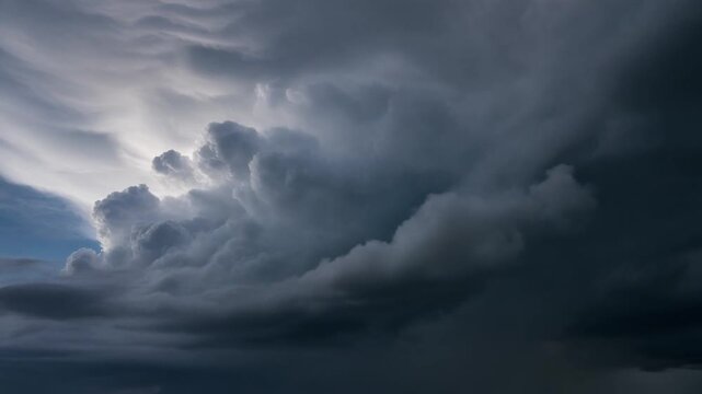 Dark ominous storm clouds gathering in the sky. Static video footage of heavy grey cumulonimbus formations. Dramatic meteorology background showing incoming severe weather conditions.