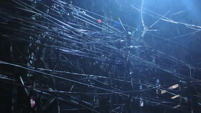 Rain pours over chaotic cables and dim street lights Metro Manila Philippines