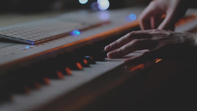 Hands playing digital piano keys in low light, musician performing on keyboard instrument. Cinematic music scene with soft glow, creativity and emotion, artistic expression, practice