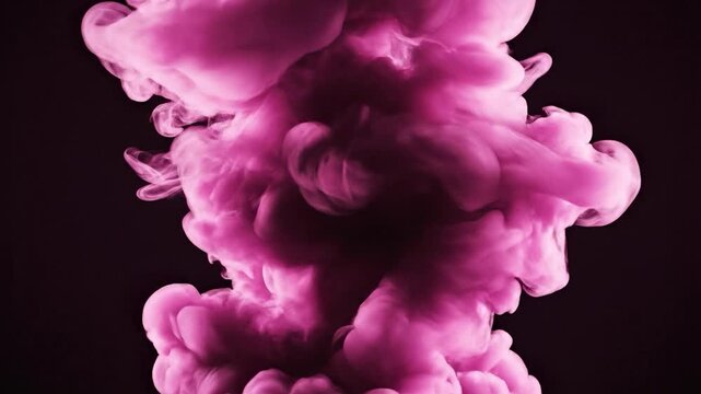 A vibrant pink cloud of smoke billows upwards against a dark background, creating an abstract and dynamic visual effect