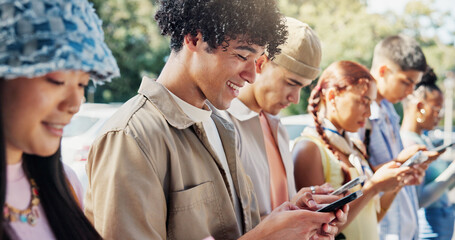 Fototapeta premium Man, smile and students in college with phone, text message notification or social media on break. Happy, person and scroll outdoor on university campus with tech, mobile app or online communication.