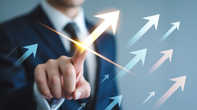 Professional in suit points to ascending arrow icon representing business development and progress