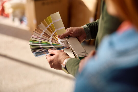 Close up of man choosing colors with his wife during home remodeling project.