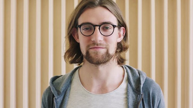 Face, IT technician and man in office, smile and nerd with glasses for clear vision. Person, employee and code developer in workplace, geek and web development for software maintenance and coding