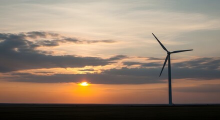 Obraz premium Wind turbines generating renewable energy at sunset in a natural landscape.