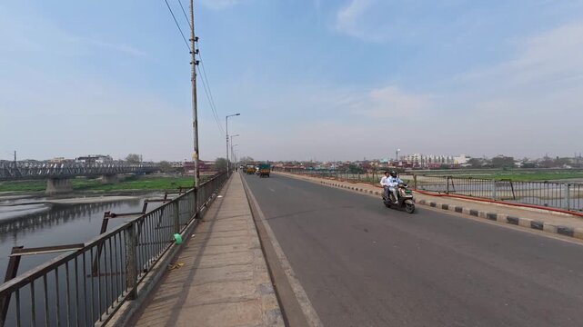 People and vehicles crossing a busy bridge in india Time lapse 4k stock video footage.