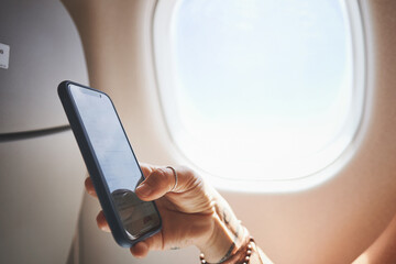 Hands, phone screen and person in plane for travel, boarding pass or check flight details. Transport, airplane mode or passenger with mobile in cabin for global journey, airline app or digital ticket © peopleimages.com