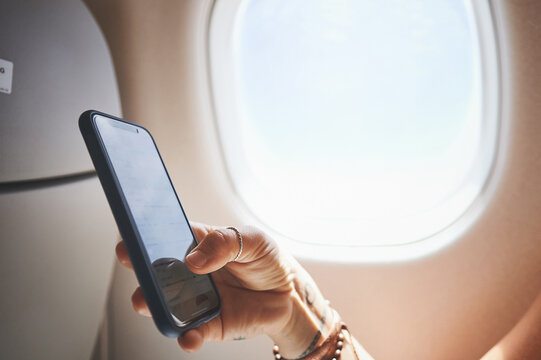 Hands, phone screen and person in plane for travel, boarding pass or check flight details. Transport, airplane mode or passenger with mobile in cabin for global journey, airline app or digital ticket