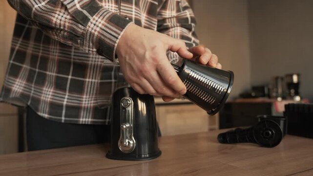 The hands of the householder assemble a manual vegetable slicer.