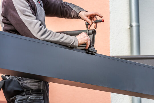 Workers install patio roofing with steel and glass