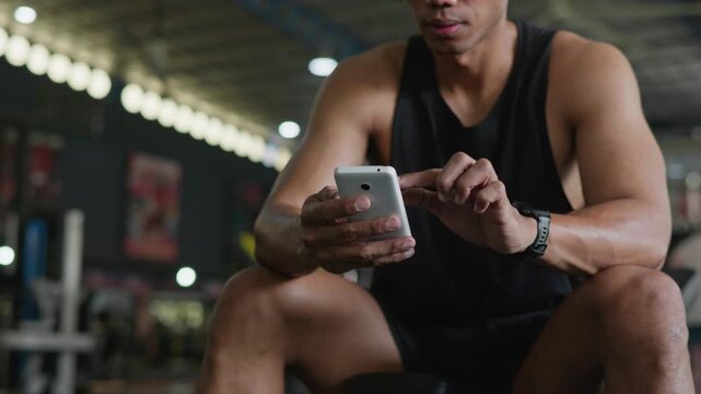 Fitness enthusiast checking workout app gym image indoor close-up health tracking