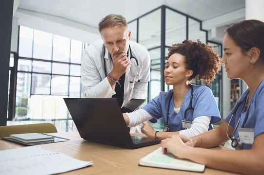 Laptop, thinking and training students with doctor in hospital for healthcare internship or residency. Computer, ideas and medical coaching with people in clinic for communication, review or study