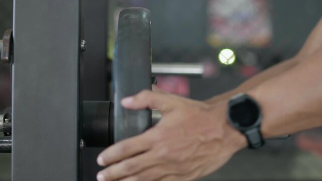 Strength training session gym fitness equipment indoor close-up muscle development