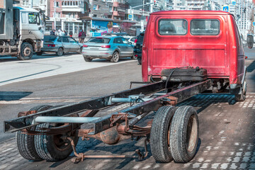 Naklejka premium A broken truck is parked on the street on a spring day