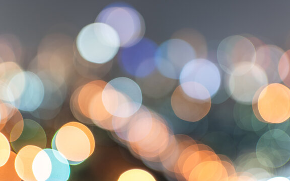 Bokeh blurred background city night light or blurry abstract candlelight party in  colorful vintage style purple blue green yellow orange gold color