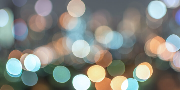 Bokeh blurred background city night light or blurry abstract candlelight party in  colorful vintage style purple blue green yellow orange gold color