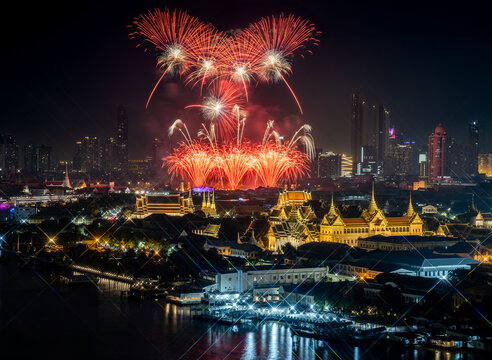 Top view of Chao Phraya River Cruise Boat with The Grand Palace and The Emerald Buddha Temple, Chakri Maha Prasat Throne Hall in New year firework festival performance.