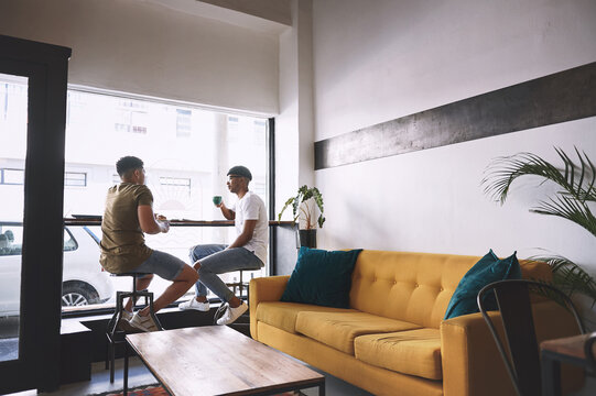 Talking, drink and window with friends at coffee shop for bonding, communication and get together. Social reunion, support and beverage with men at cafe for discussion, relax and gossip chat