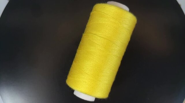 sewing thread spool rotating in top-down view with smooth motion and clean composition.