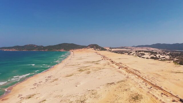Sweeping Aerial Drone View of Vast Sandy Coastal Terrain at Bai Hon Cat Tham with Turquoise Sea and Island Backdrop, Khanh Hoa Province, Central Vietnam, Southeast Asia