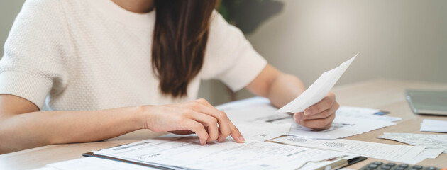 person using calculator calculating tax refund on the table