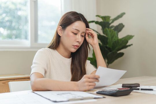person using calculator calculating tax refund on the table