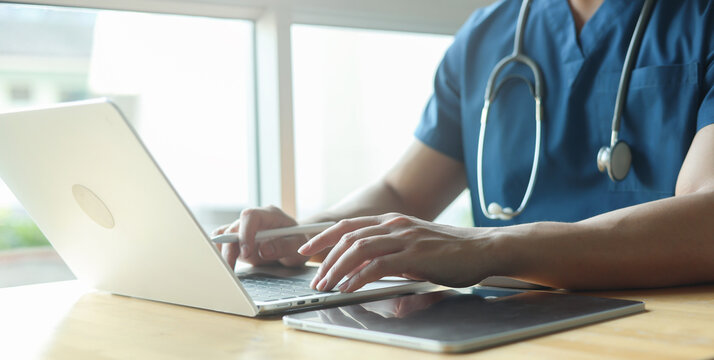 Close up specialist doctor use laptop to check about patient&rsquo;s opd and read or research about treatment at office in hospital for medical and therapy service concept