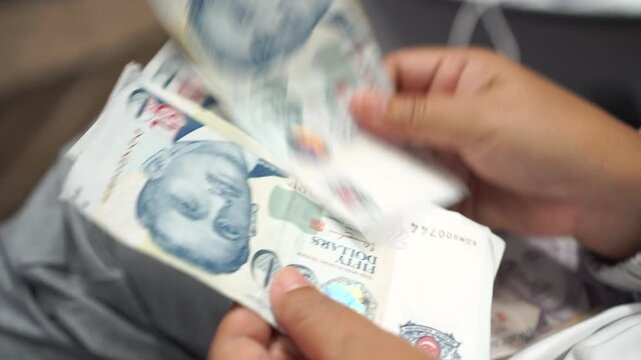 Banknote counting Singapore dollars SGD, Singapore money for payment