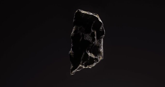 Single dark stone with golden veins floating in space highlighted by soft directional lighting.