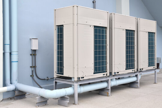 hvac conditioner units at industrial factory exterior, outdoor air conditioning compressor units for heating, cooling, ventilation and air conditioning in building